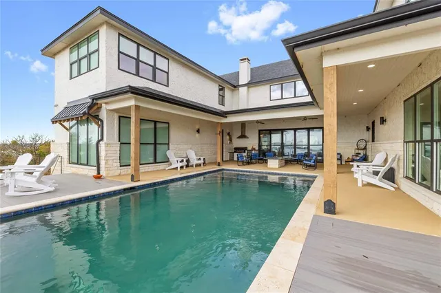 a view of swimming pool with seating area