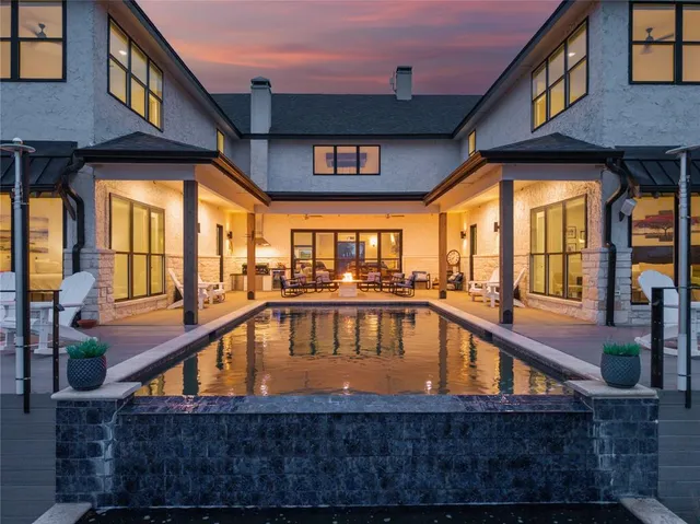 a view of a chairs and table on the wooden deck