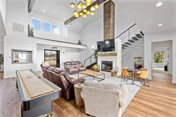 a living room with furniture or chandelier and a fireplace