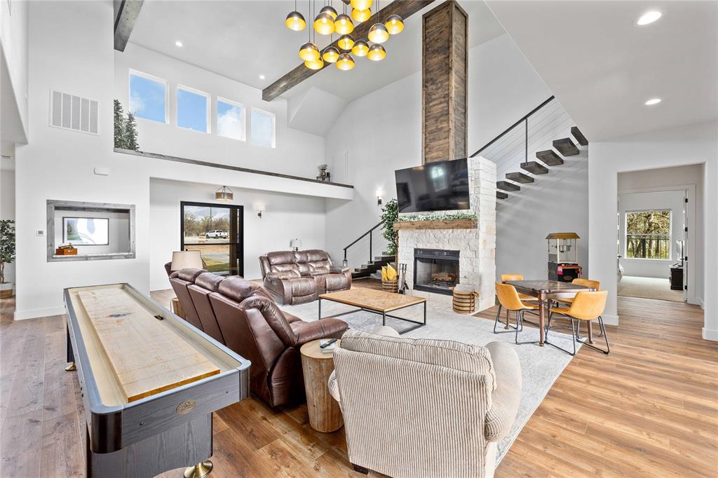 584 Oak Point Drive May, TX 76857 - Photo 9 of 40 a living room with fireplace furniture and a wooden floor