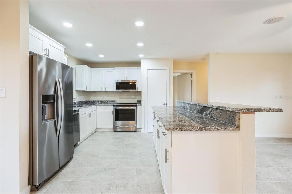 6064 Park Road Fort Myers, FL 33908 - Photo 3 of 14 a kitchen with a refrigerator a sink and dishwasher