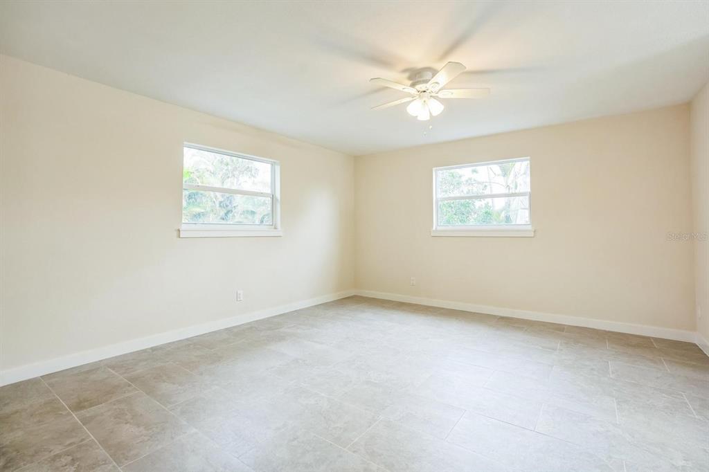 6064 Park Road Fort Myers, FL 33908 - Photo 7 of 14 an empty room with windows and fan