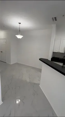 a bathroom with a granite countertop sink a toilet and a large mirror