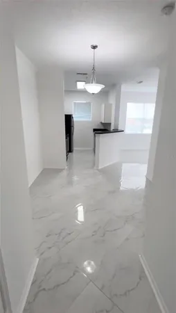 a view of a room with a chandelier and fireplace