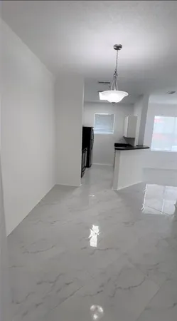 a kitchen with a refrigerator and a stove top oven
