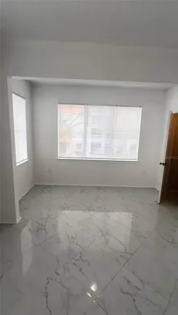 an empty room with cabinet and wooden floor