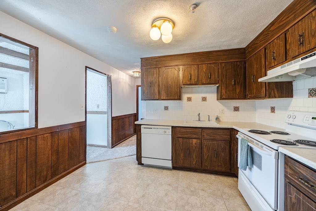 41 Spencer Road, Unit 26G Boxborough, MA 01719 - Photo 14 of 35 a kitchen with a sink cabinets and stainless steel appliances
