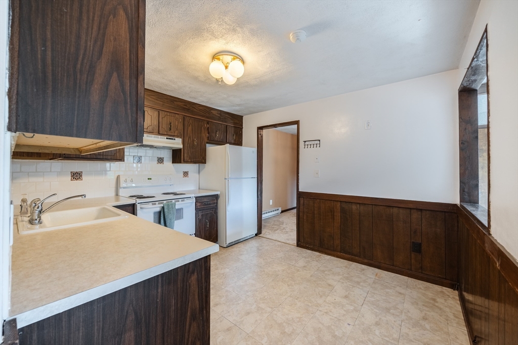41 Spencer Road, Unit 26G Boxborough, MA 01719 - Photo 17 of 35 a kitchen with refrigerator and cabinets