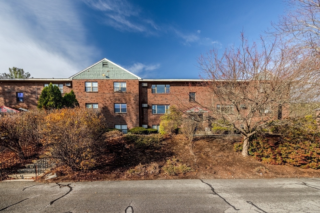 41 Spencer Road, Unit 26G Boxborough, MA 01719 - Photo 32 of 35 a front view of a house with a yard