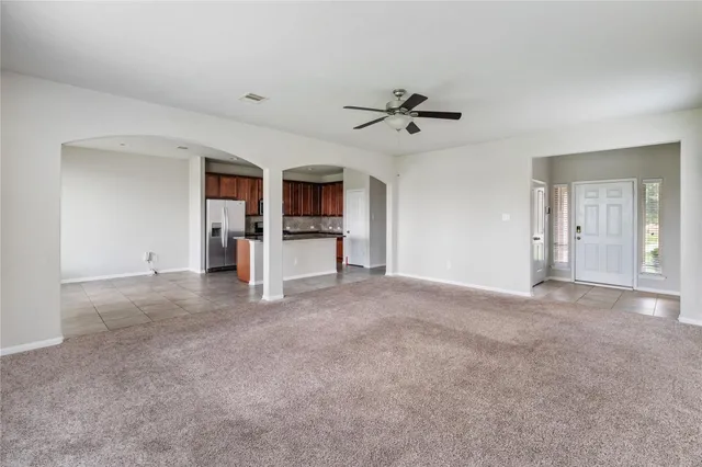 a view of a livingroom with a fireplace and a ceiling fan
