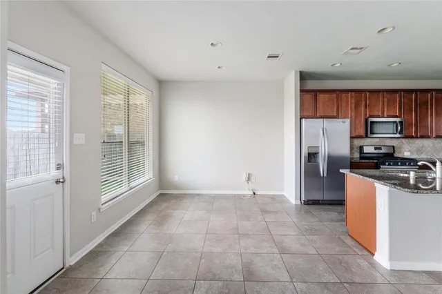 a kitchen with a refrigerator a stove top oven a sink and dishwasher