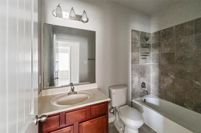 a bathroom with a sink toilet a mirror and shower