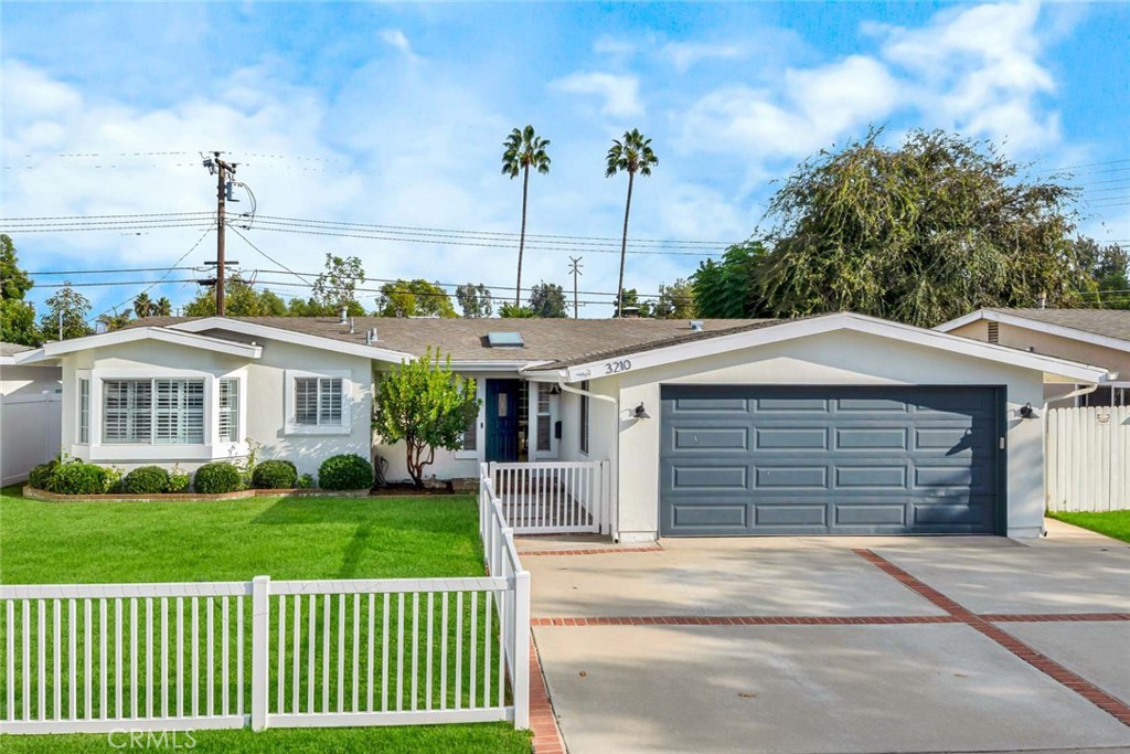 3210 Iowa Street Costa Mesa, CA 92626 - Photo 1 of 18 a front view of a house with a garden and plants