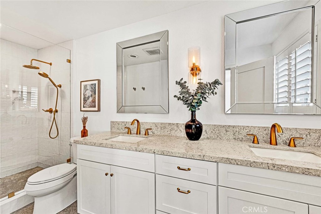 3210 Iowa Street Costa Mesa, CA 92626 - Photo 11 of 18 a bathroom with a granite countertop sink a toilet and a mirror