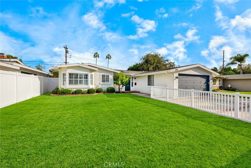 3210 Iowa Street Costa Mesa, CA 92626 - Photo 16 of 18 a front view of a house with a yard