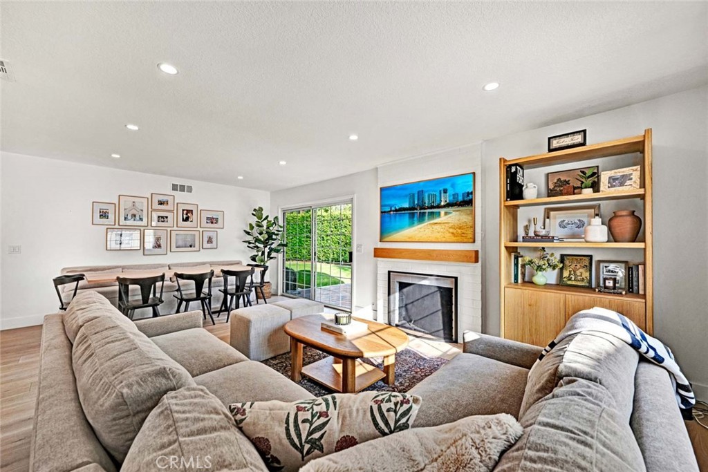3210 Iowa Street Costa Mesa, CA 92626 - Photo 6 of 18 a living room with furniture fireplace and wooden floor