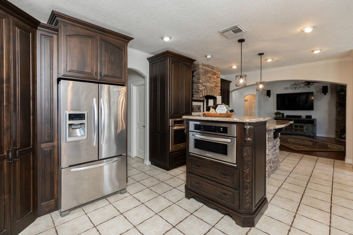 665 Winchester Drive Bridge City, TX 77611 - Photo 25 of 39 a kitchen with stainless steel appliances a refrigerator and a stove top oven
