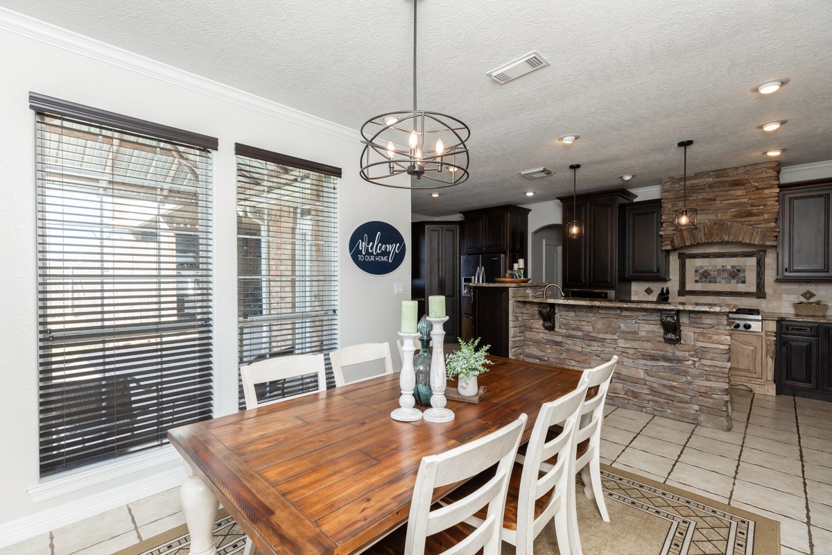 665 Winchester Drive Bridge City, TX 77611 - Photo 30 of 39 a view of a dining room with furniture and a chandelier