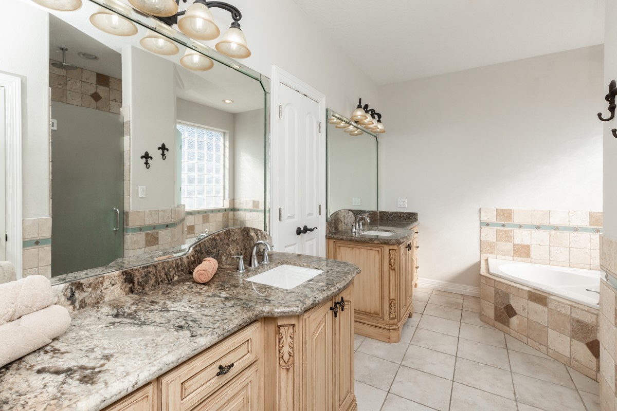 665 Winchester Drive Bridge City, TX 77611 - Photo 32 of 39 a bathroom with a granite countertop sink and a mirror