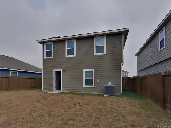 a brick house with a yard and garage