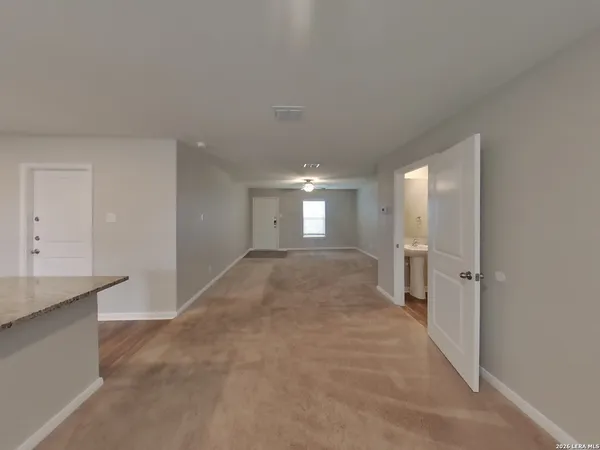a view of a big room with closet and windows