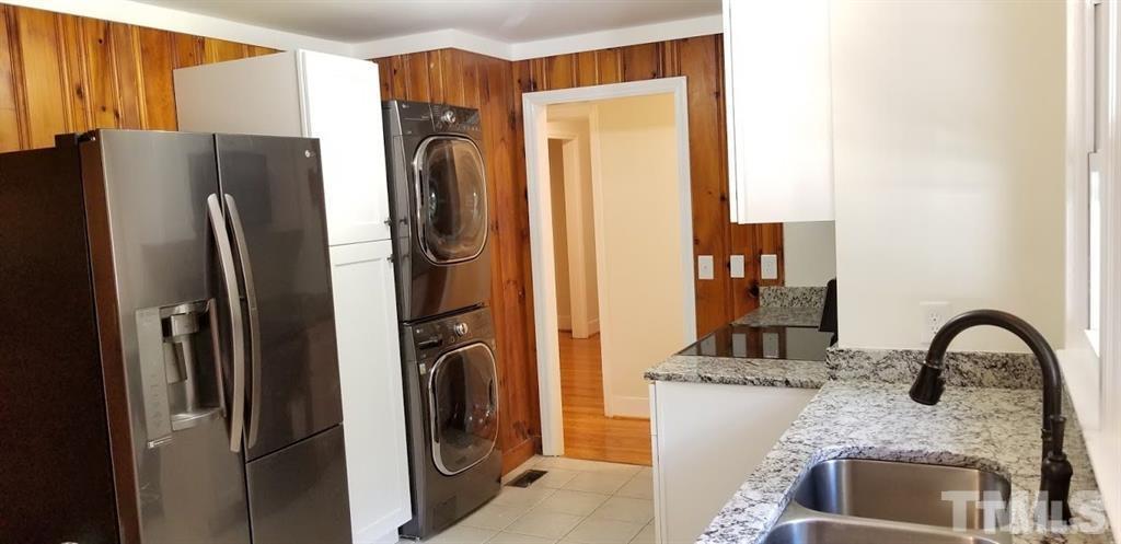 2925 Mt Moriah Road Durham, NC 27707 - Photo 3 of 18 a kitchen with stainless steel appliances granite countertop a refrigerator and a sink