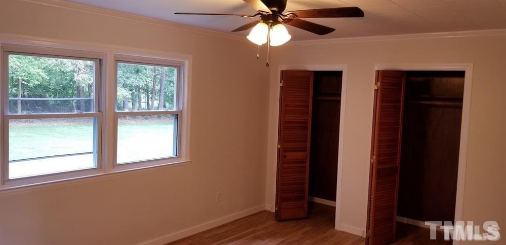 2925 Mt Moriah Road Durham, NC 27707 - Photo 5 of 18 a view of an empty room with wooden floor and a window