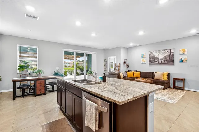 a kitchen with sink and chairs