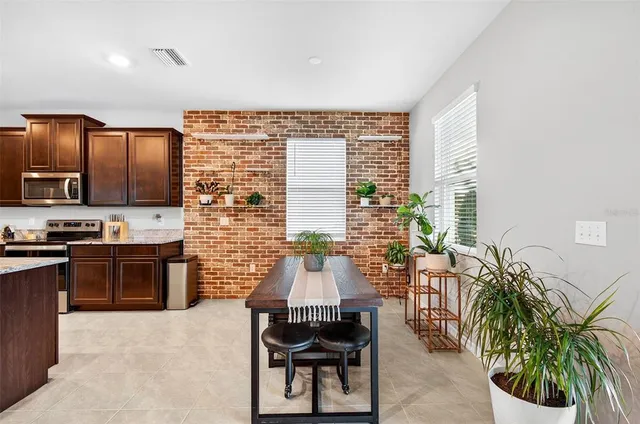 a kitchen with granite countertop a stove a sink and a microwave
