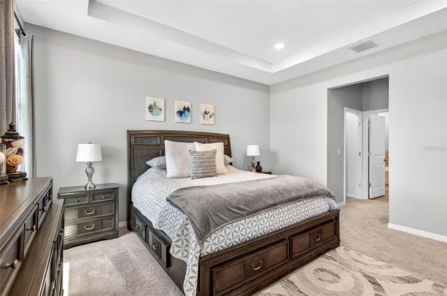 a bedroom with a bed and a night stand