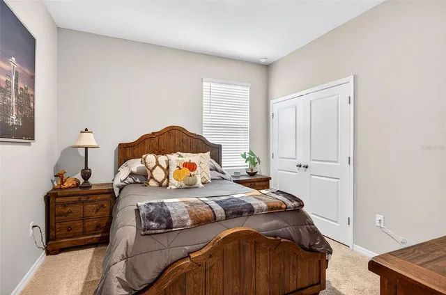 a bedroom with a bed and a lamp