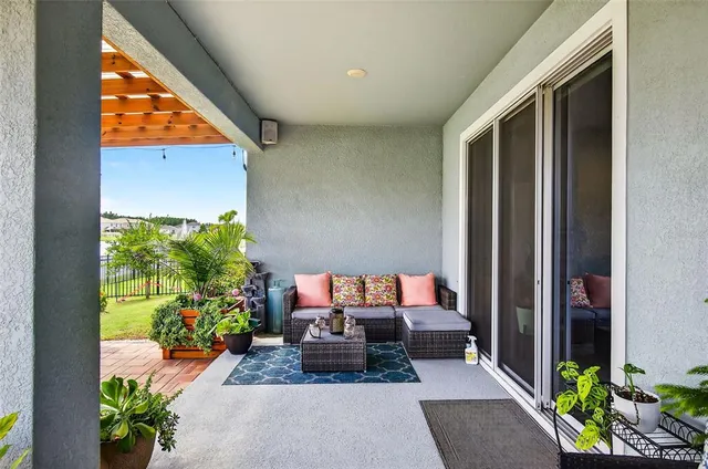 a view of a porch with furniture and garden