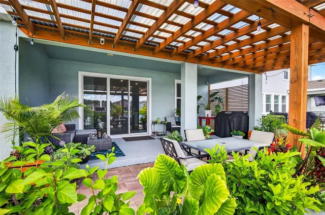 a front view of a house with yard and outdoor seating