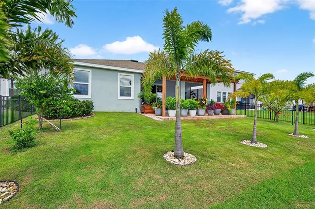 a front view of house with a garden and plants