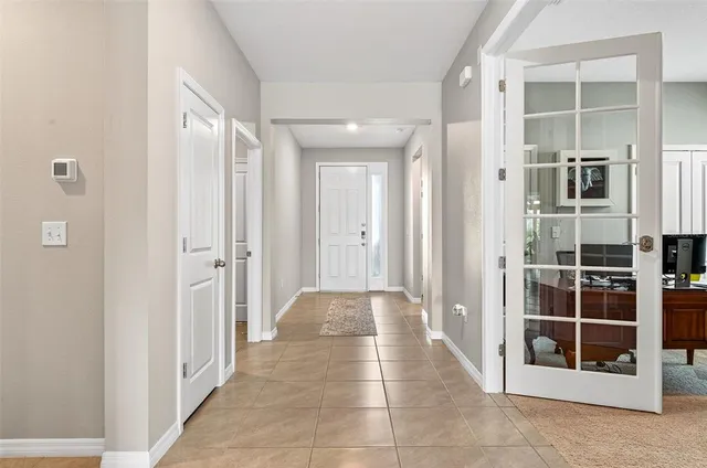 a view of a hallway with wooden shelves