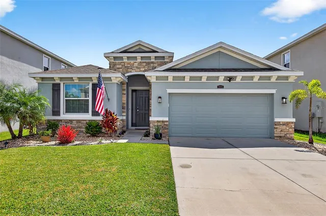a front view of a house with a yard and garage