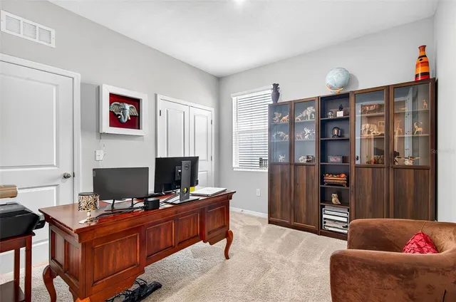 a view of a workspace with furniture and cabinet