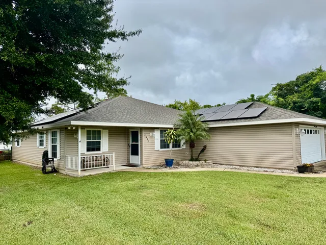 a front view of house with yard and green space