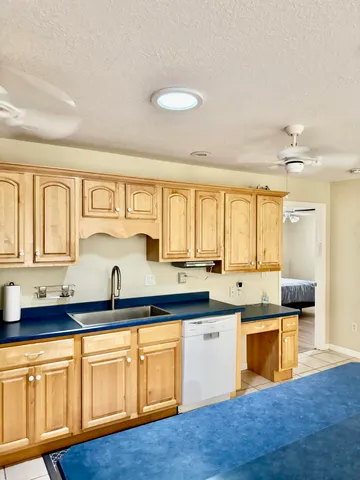 a kitchen with stainless steel appliances granite countertop a sink and cabinets