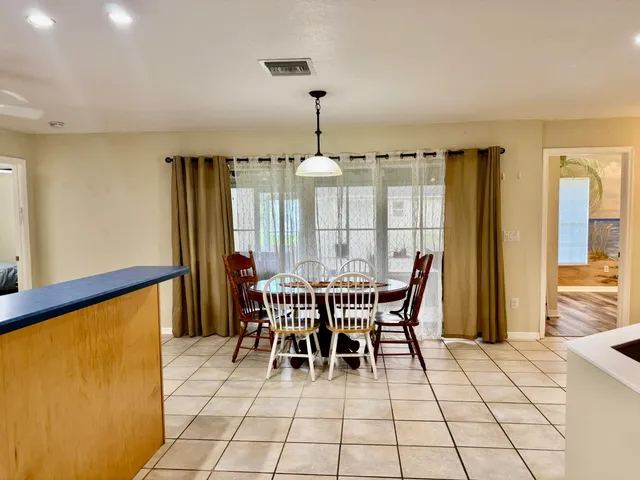 a kitchen with granite countertop a sink a counter top space cabinets and stainless steel appliances