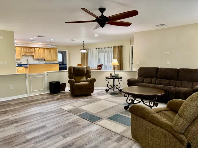 a living room with furniture ceiling fan and a rug