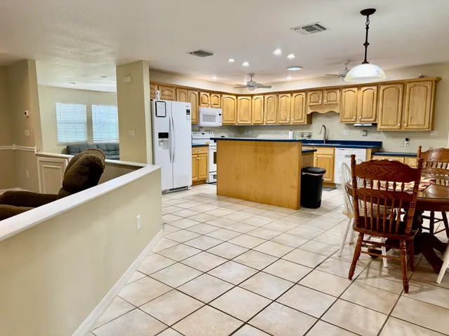 a large kitchen with a table and chairs