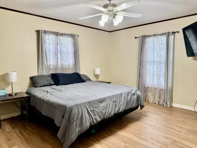 a bedroom with a bed lamp and a chandelier
