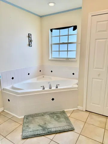 a bathroom with a tub sink and mirror