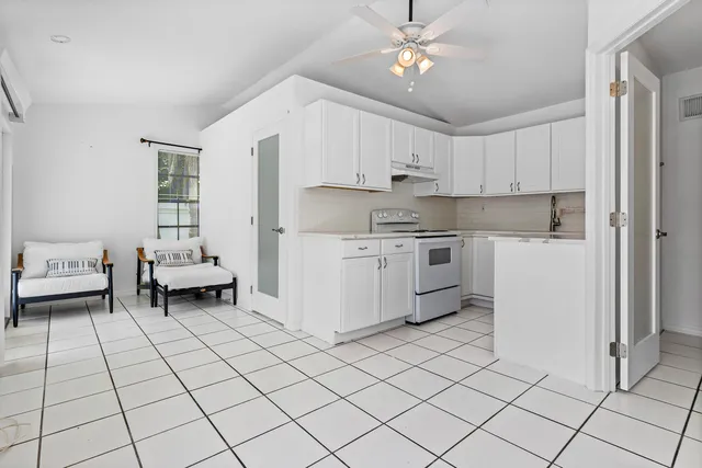 a kitchen with a sink cabinets and window