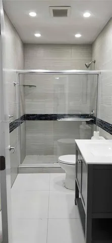 a bathroom with a sink a toilet and a shower