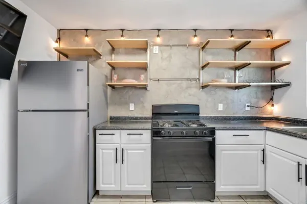 a kitchen with cabinets and stainless steel appliances
