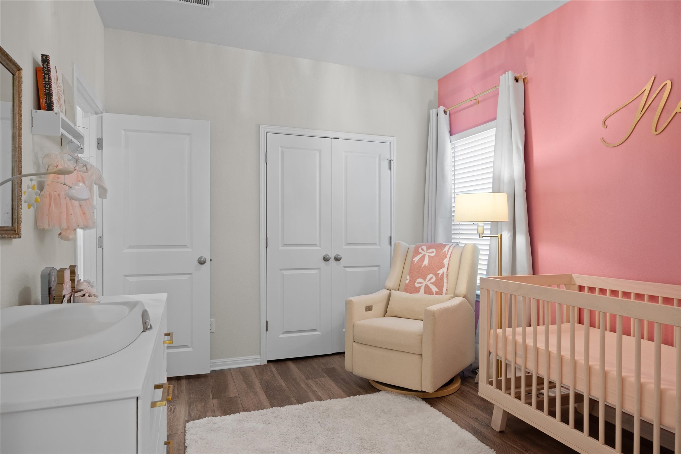 313 Toddy Way Leander, TX 78641 - Photo 24 of 39 Bedroom with a nursery area, dark wood-style floors, and a closet - the wall is no longer pink