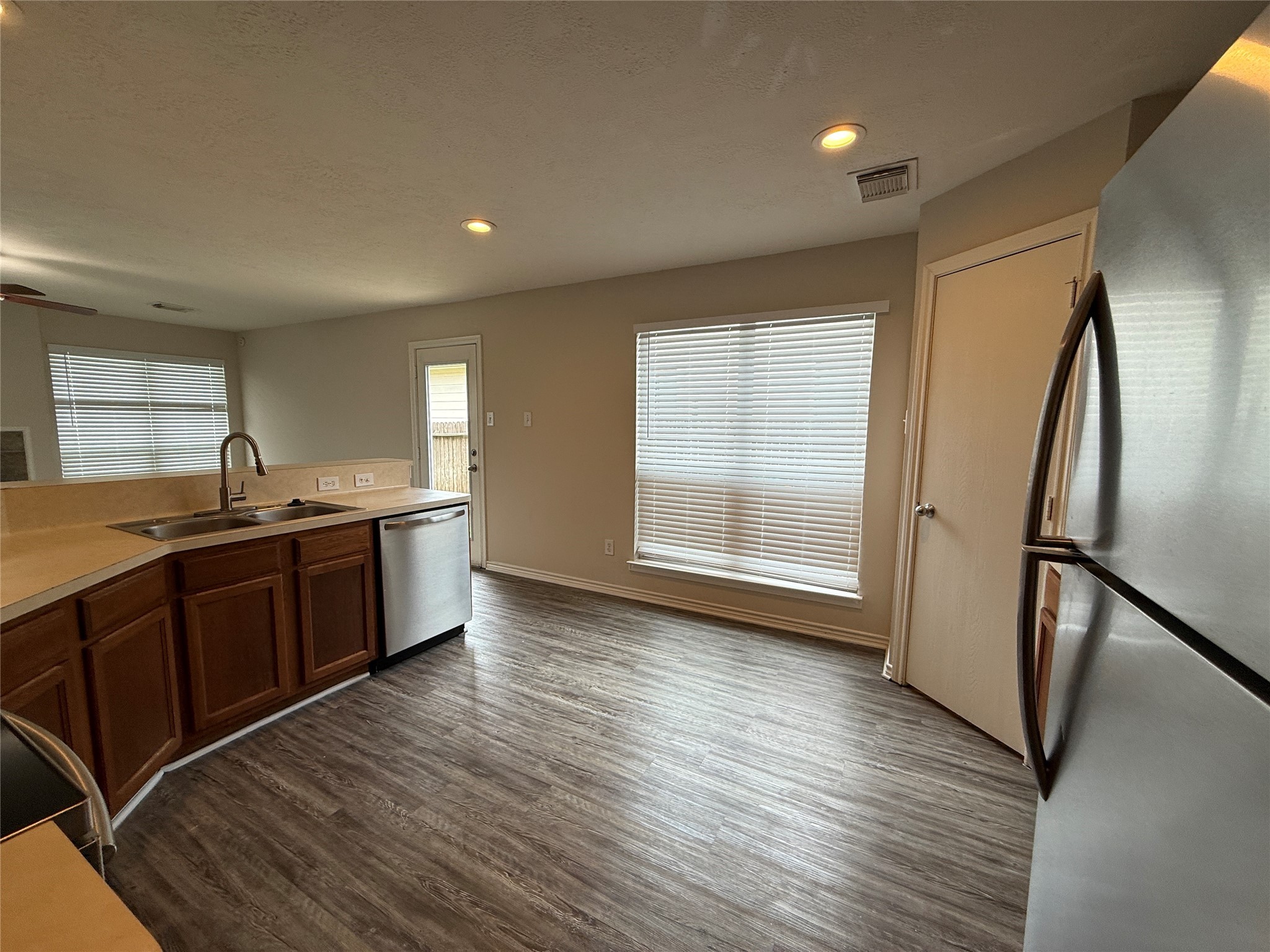 2325 Shady Tree Lane Conroe, TX 77301 - Photo 6 of 22 a large kitchen with stainless steel appliances granite countertop a large counter top a sink and a refrigerator