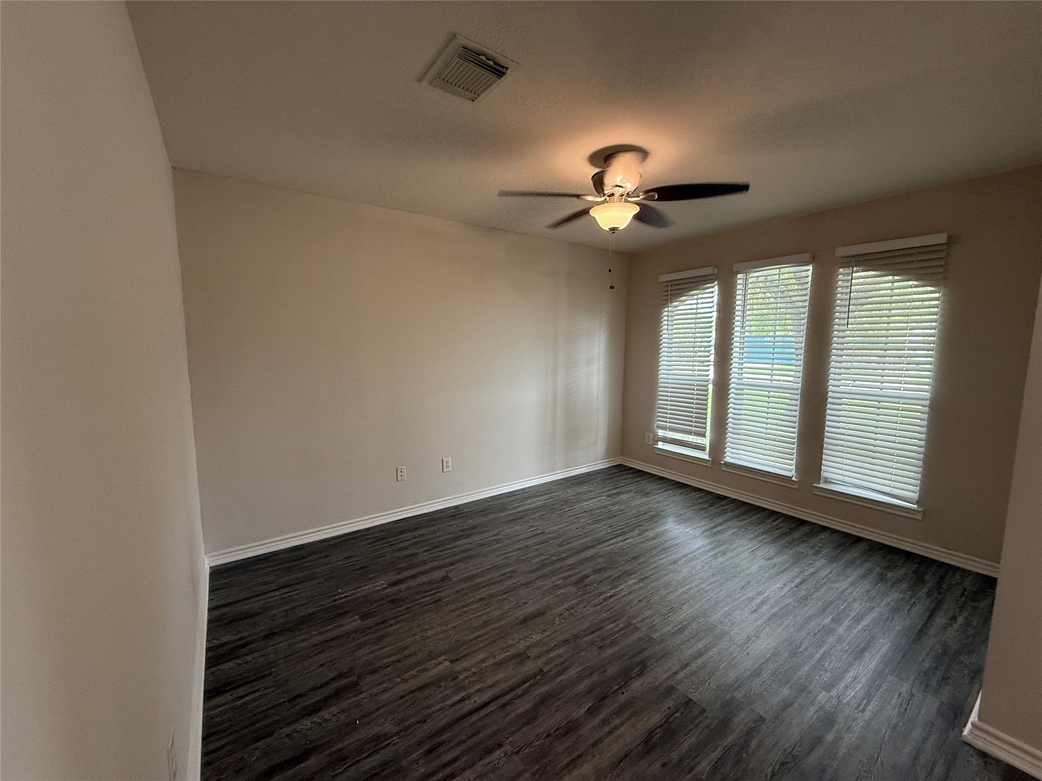 2325 Shady Tree Lane Conroe, TX 77301 - Photo 8 of 22 a view of an empty room with a window and wooden floor
